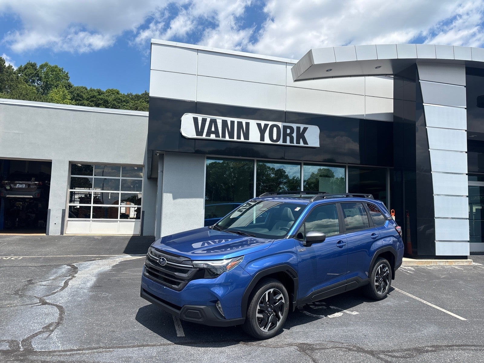 2026 Subaru FORESTER Premium Hybrid in Daybreak Blue Pearl — front three-quarter view