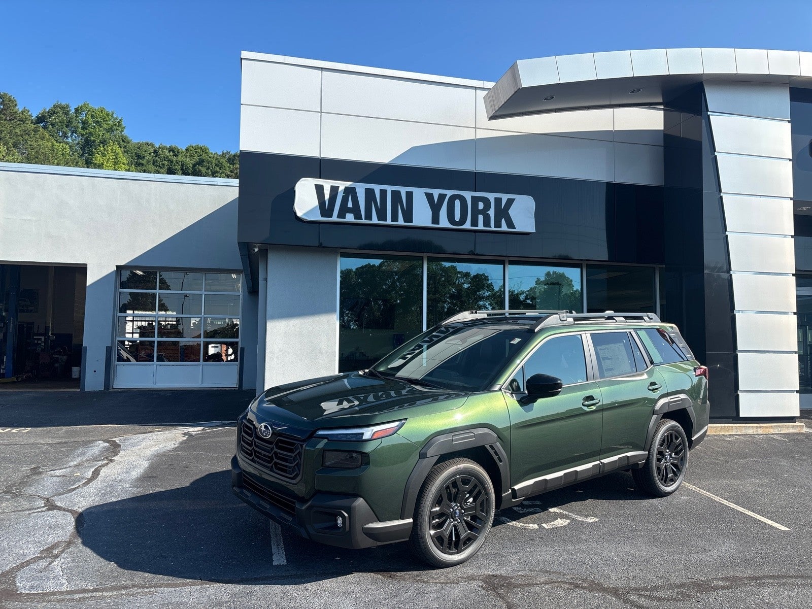 2026 Subaru OUTBACK Limited XT in Deep Emerald Green Pearl — front three-quarter view