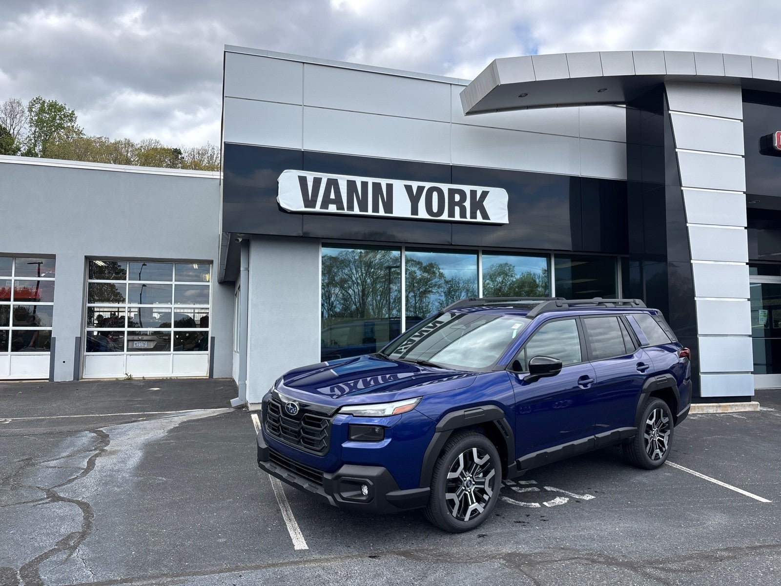 2026 Subaru OUTBACK Touring XT in Sapphire Blue Pearl — front three-quarter view