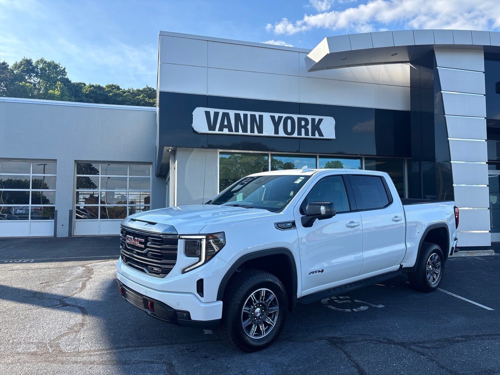 2024 GMC Sierra 1500 AT4 in Summit White — front three-quarter view